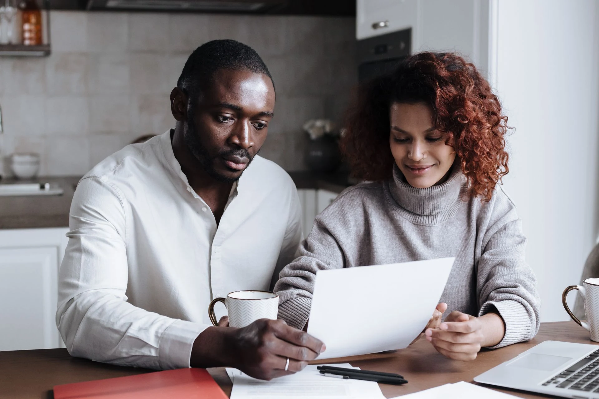 Couple reading a document together at a table