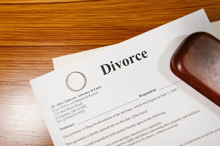 Divorce papers lying on a wooden desk