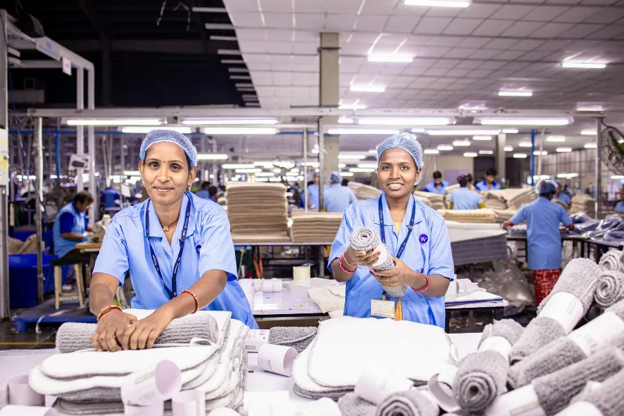 Workers in uniforms at a textile production line