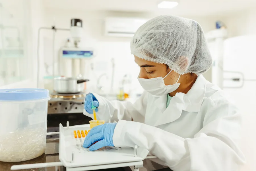 Scientist in protective clothing working with samples in a laboratory
