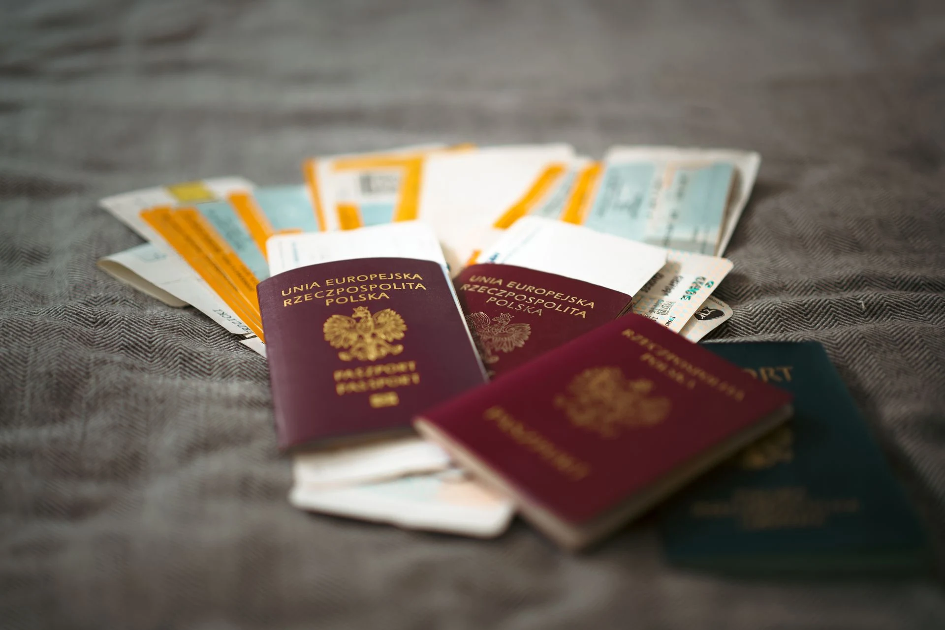 Two passports lying on boarding passes and travel documents